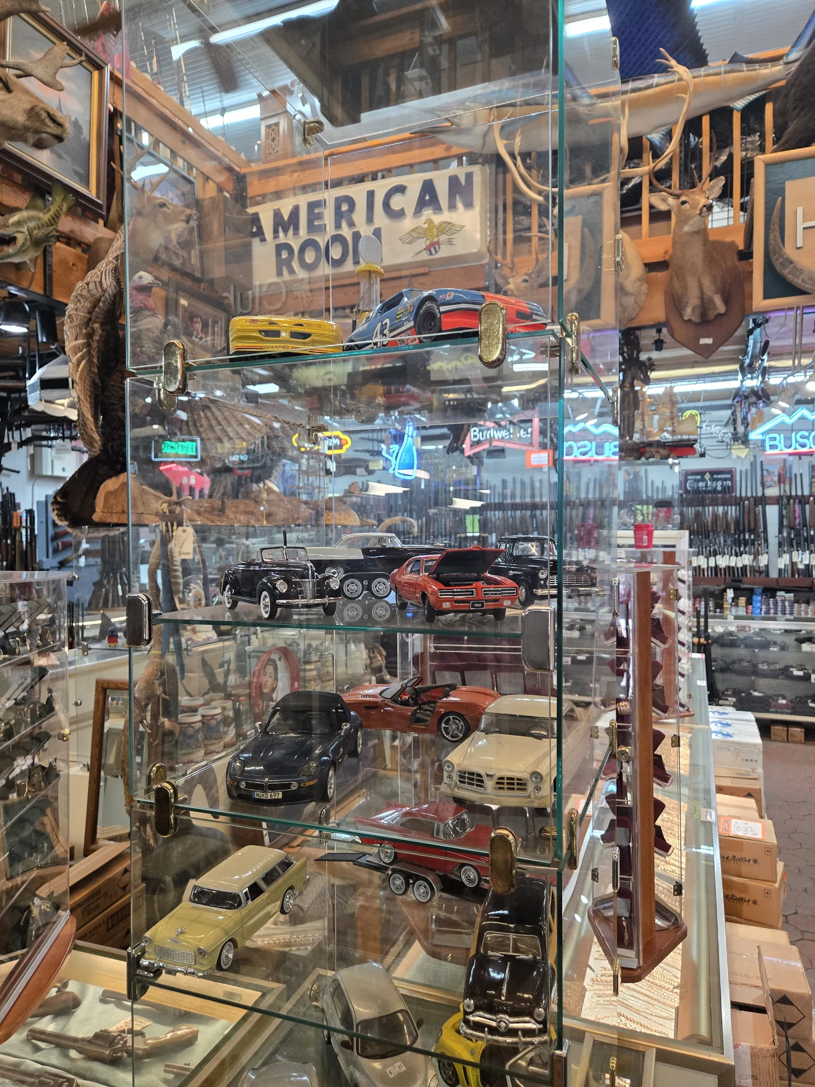 Glass case of collectible model cars in the American Room at AAA Gun & Pawn