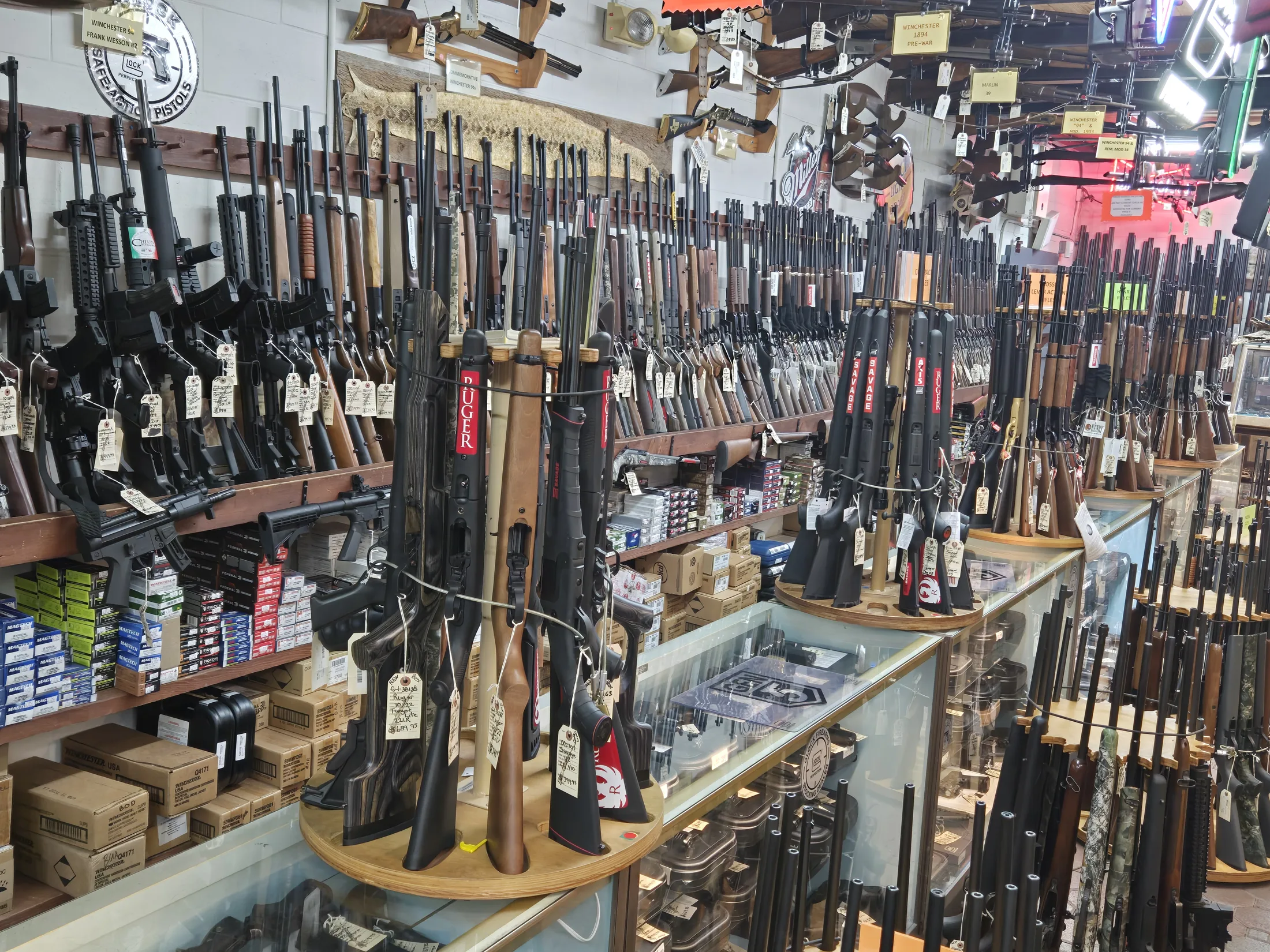 Racks of shotguns and rifles along the firearms wall at AAA Gun & Pawn