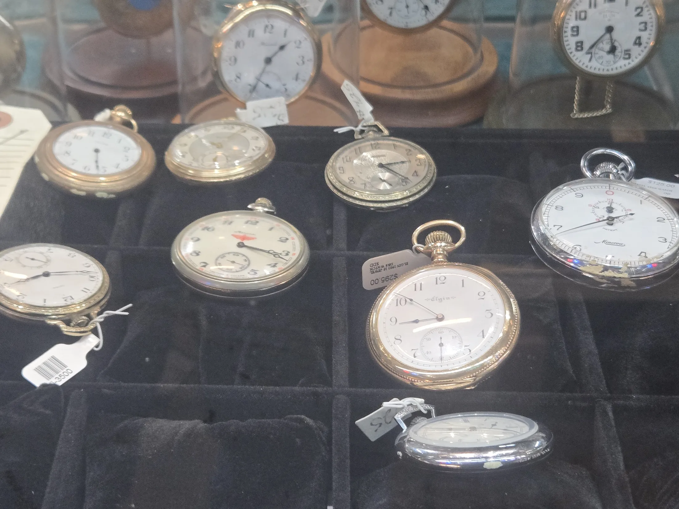 Pocket watches on a tray in the jewelry showcase at AAA Gun & Pawn